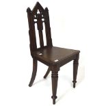 A late 19th century oak hall chair, with Gothic pierced decoration to the back,
