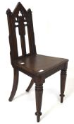 A late 19th century oak hall chair, with Gothic pierced decoration to the back,