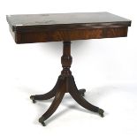 A late 19th century mahogany folding card table, opening to reveal a green baize,
