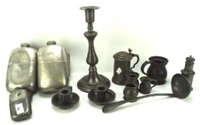 A collection of pewter wares, to include two oversized flasks, sauce ladle,