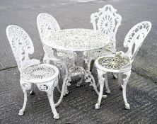 A group of vintage white painted aluminum garden furniture, including a table and four chairs,