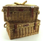 A selection of three wicker baskets, two having rope handles,