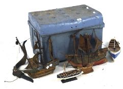 A vintage blue painted metal storage box containing a selection of model ships,