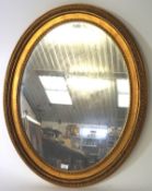 A 20th century gilt framed mirror, of oval form, the frame with moulded details,