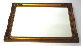 A bevelled edge gilt framed wall mirror, of rectangular form, with moulded details,