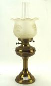 An early 20th century brass oil lamp, with moulded glass shade and clear glass funnel,