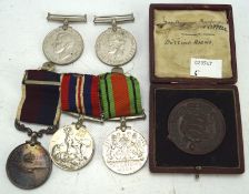 Five medals and a bronze plaque,