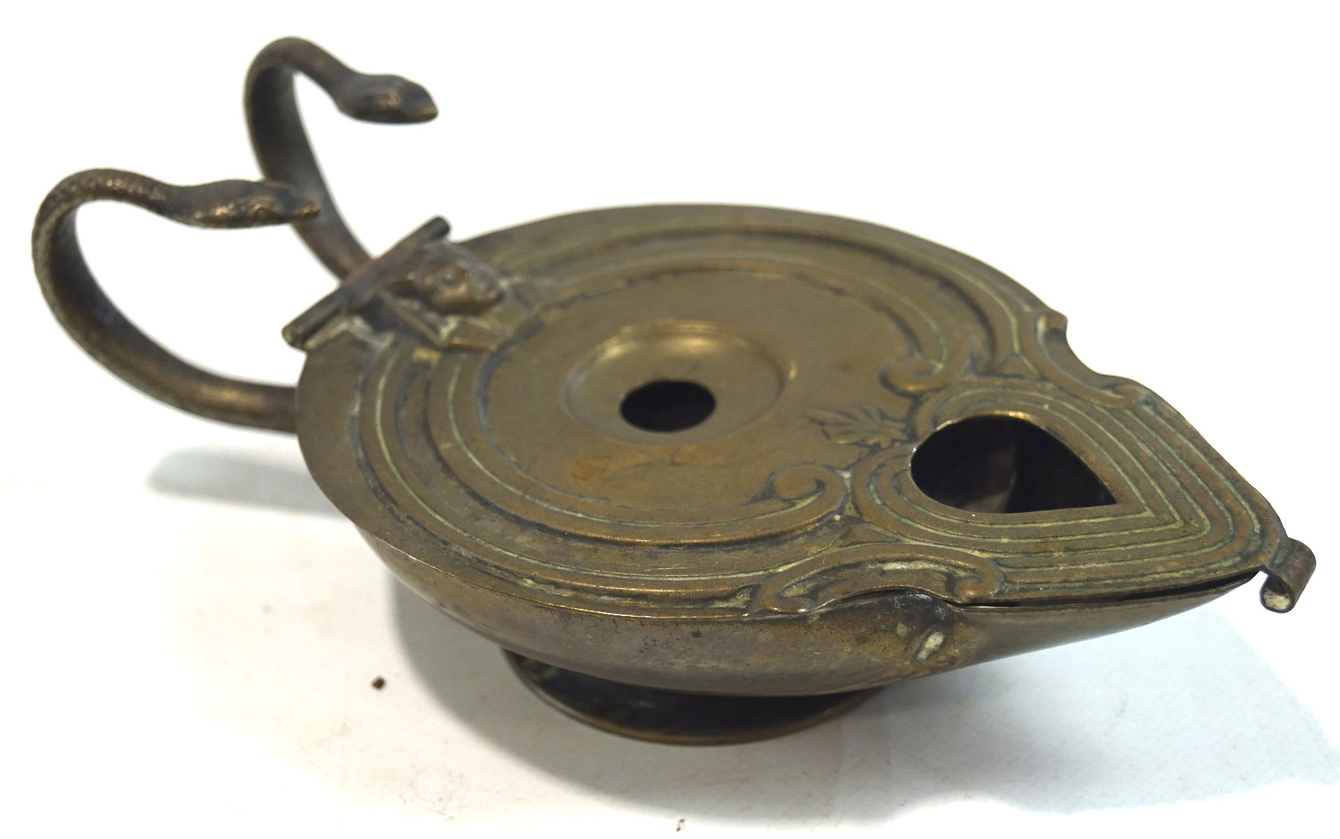 A small Egyptian brass oil lamp, its handles in the form of snakes, impressed mark to base, - Image 2 of 3