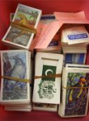 A collection of cigarette cards and stamps, mostly 20th century, featuring animals and plants,