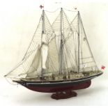 A painted wood model of a yacht named the SIr Winston Churchill, the sail marked TSK1,