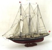 A painted wood model of a yacht named the SIr Winston Churchill, the sail marked TSK1,