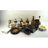 An assortment of advertising pub memorabilia including water jugs, ashtrays, Bell Decanters.