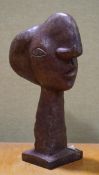 A vintage Picasso style bronze figure depicting a stylized head,