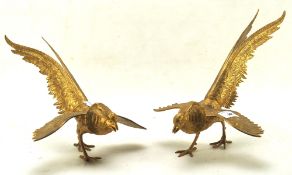 A contemporary pair of gilt metal pheasants with spread wings,