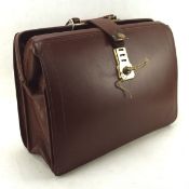 A vintage 1960's/ 70's leather travelling bag, with cheney locks,