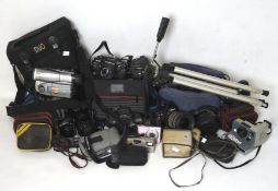 A collection of cameras and accessories, including a tripod, Nikon D40, Miranda Solo AF2,
