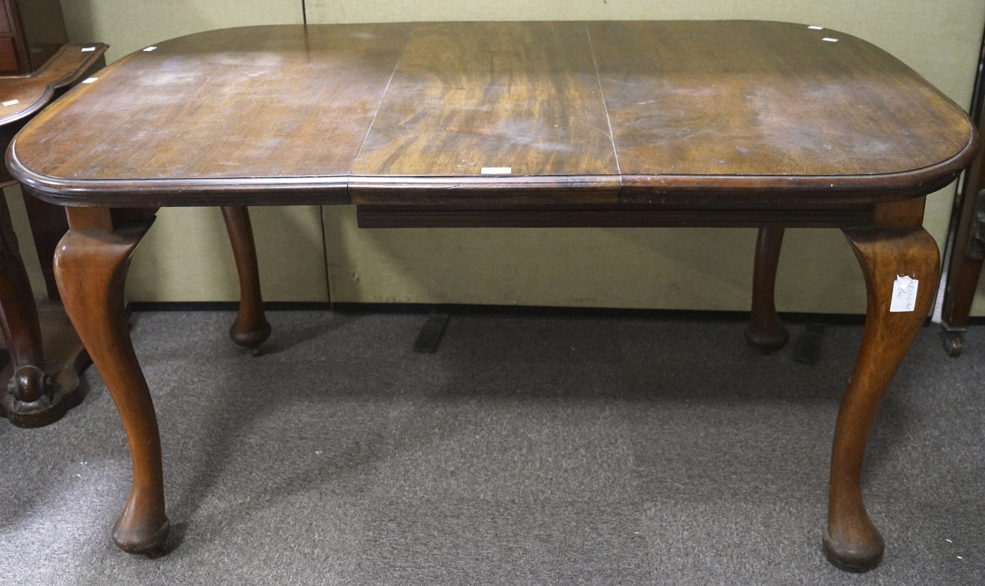 A Victorian mahogany wind out dining table, with an extra leaf,