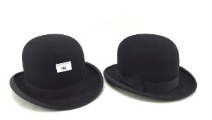 Two black bowler hats,