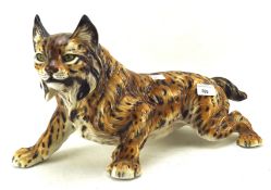 A large ceramic model of a striding lynx,