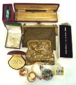 A domed box of vintage jewellery, including two gold coloured clutch bags, necklaces,