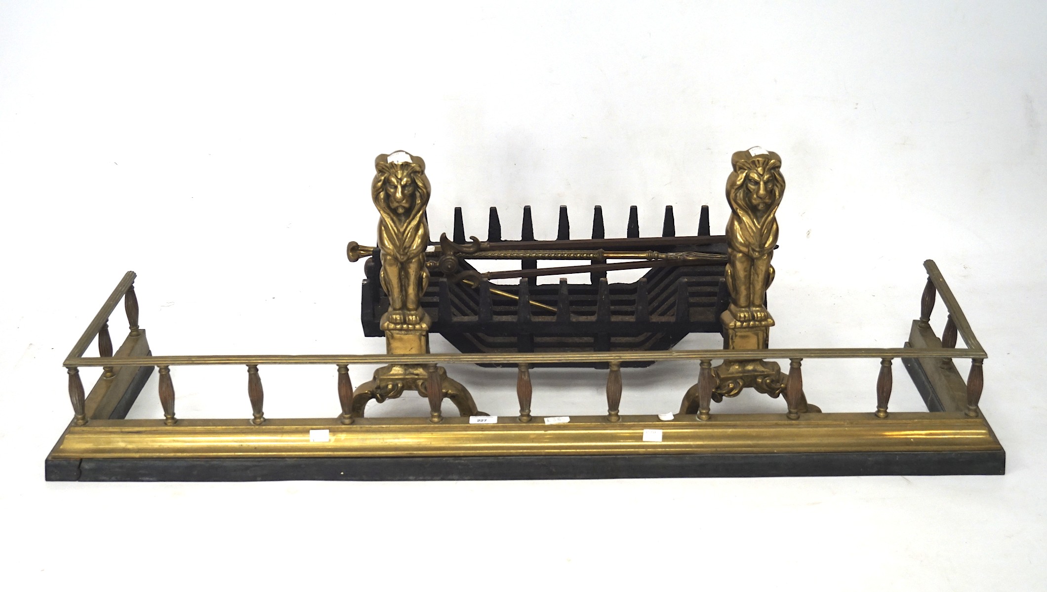 A quantity of fireside items including firedogs in the form of lions, curb, width 134cm, grate,