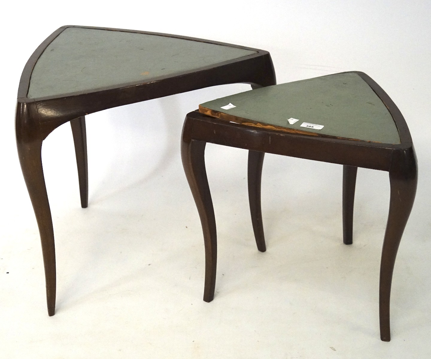 A pair of triangular side tables, with mahogany veneered frames and inset with green leather,