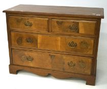 A late 19th/early 20th century veneered four drawer chest of drawers with inlaid banding,
