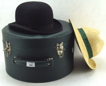 A vintage hat box containging two hats, one being by Dunn & co,