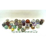 A collection of glass paperweights, to include one by Isle of White glass,