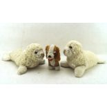 A group of three Merrythought soft toys, comprising two seals and a small dog,