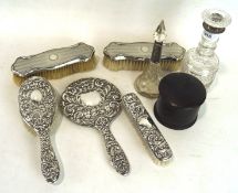 A silver and glass dressing table set, including silver backed brushes, a hand mirror,