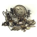 A collection of silver plate to include place mats, a tray, candelabra, coffee pot, flatware,