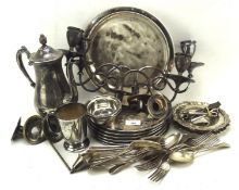 A collection of silver plate to include place mats, a tray, candelabra, coffee pot, flatware,