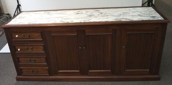 A marble topped mahogany sideboard, featuring four drawers to the left and three cuboards,