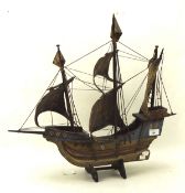 A painted wooden model galleon ship on a stand,
