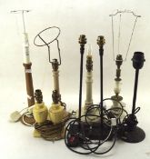 A collection of assorted table lamps, including wooden and metal examples,