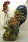 A highly coloured large ceramic model of a cockerel,