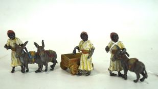 Three coal painted lead figures, in Middle Eastern attire,