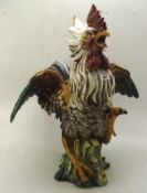 A large ceramic figure of a fighting cock,