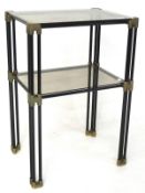 A contemporary glass topped two tier metal occational table, of rectangular form,