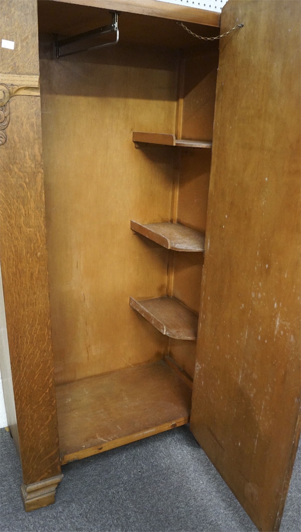 A mid century oak wardrobe, the front adorned with carved scrolling motifs, - Image 2 of 2