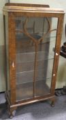 An Art Deco walnut glazed display cabinet, with three internal glass shelves,