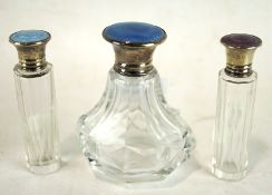 Three enamel topped silver mounted glass scent bottles,