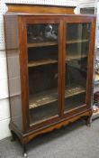 An early 20th century mahogany display cabinet with galleried back and dounble glazed doors,