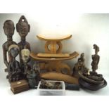 A collection of wood, metal and ceramic ethnographical items including seated and standing figures,