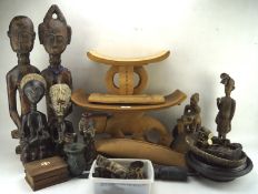 A collection of wood, metal and ceramic ethnographical items including seated and standing figures,