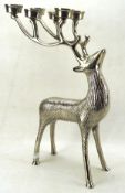 A cast metal candle holder modelled as a stag,