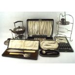 A collection of silver plated wares, including two chamber sticks, plate holder, kettle, flatware,