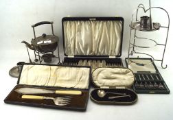 A collection of silver plated wares, including two chamber sticks, plate holder, kettle, flatware,