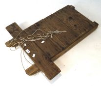 A vintage wooden sledge, formed of six wooden slats, on metal mounted rails,